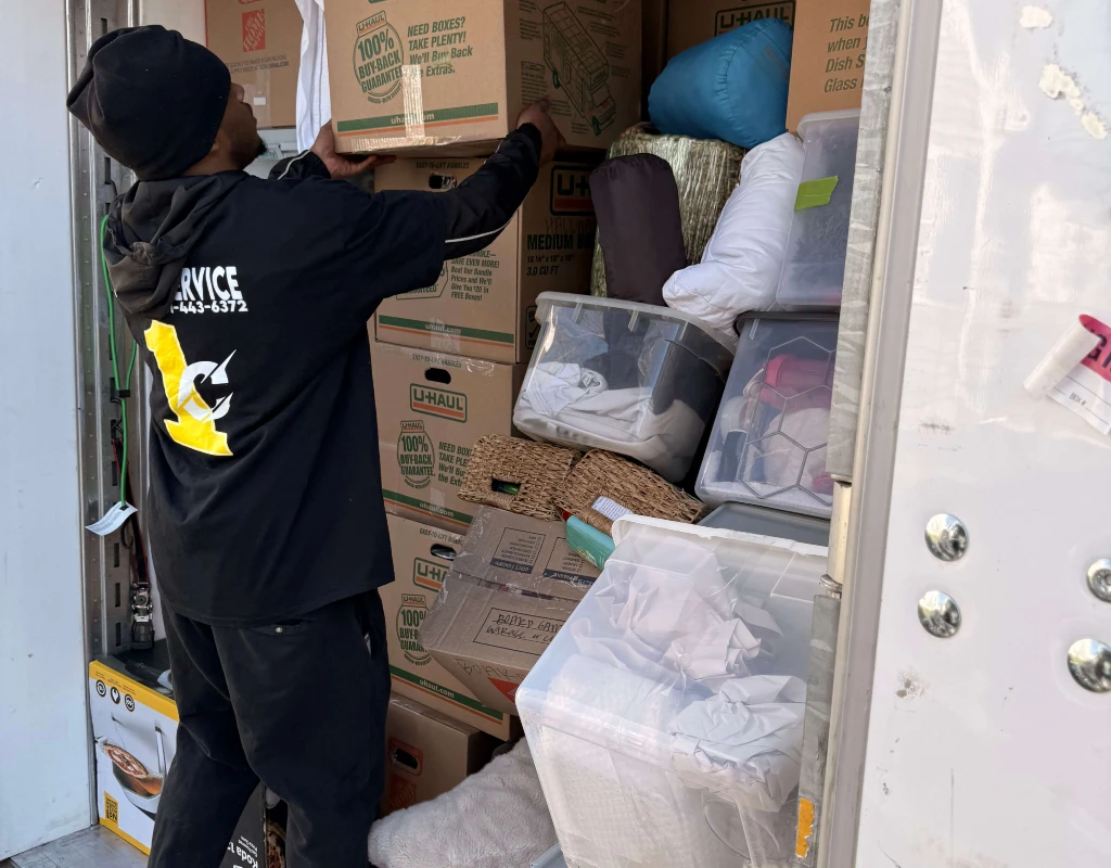image of a mover packing goods for a long distance move